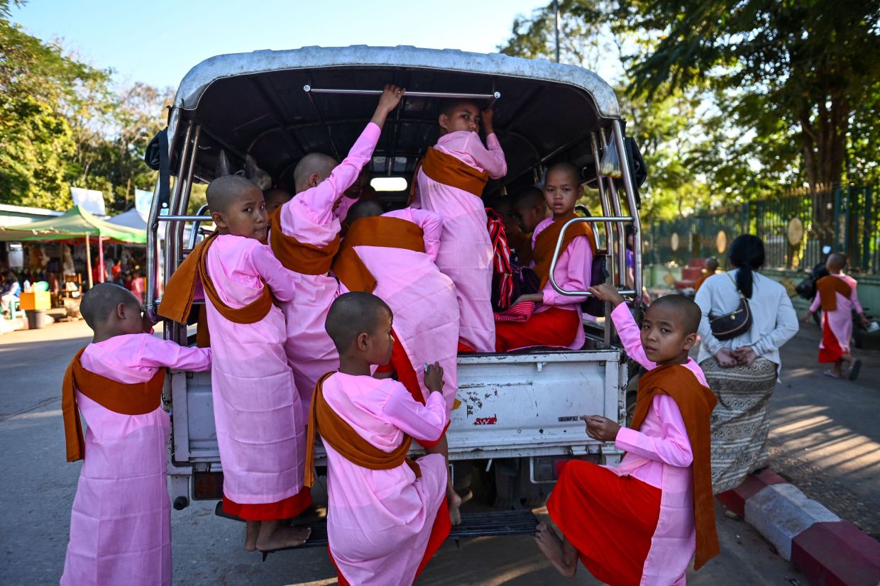 Buddhist nuns leave after visiting the Uppatasanti Pagoda a day before Myanmar's general election in Naypyidaw on Saturday, December 27, 2025. Myanmar's junta said on December 26 it will lift a curfew imposed in Yangon since its 2021 coup, just days before the start of elections it touts as a return to normality. -- Photo by Sai Aung MAIN / AFP
