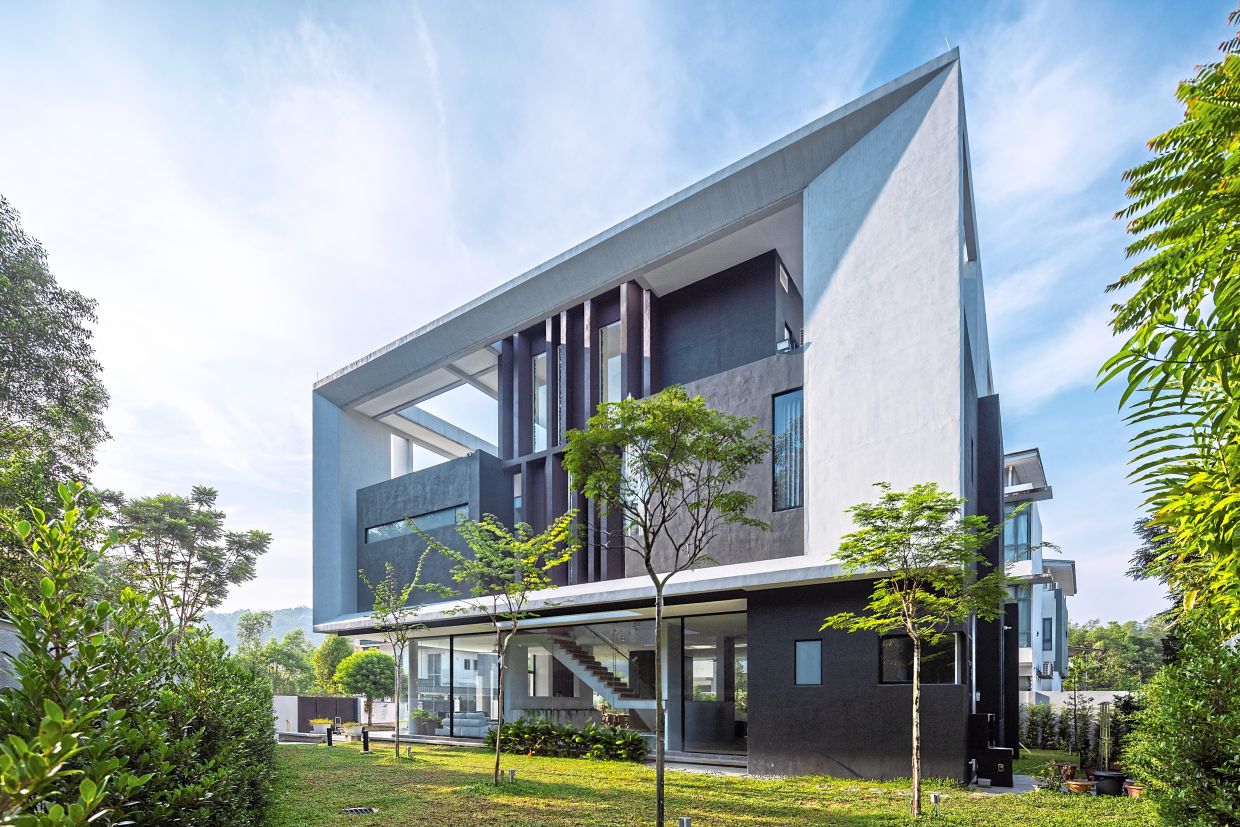 A large white box envelops smaller dark boxes, the former serving as the unifying form, while the darker ones contain spaces within the structure.