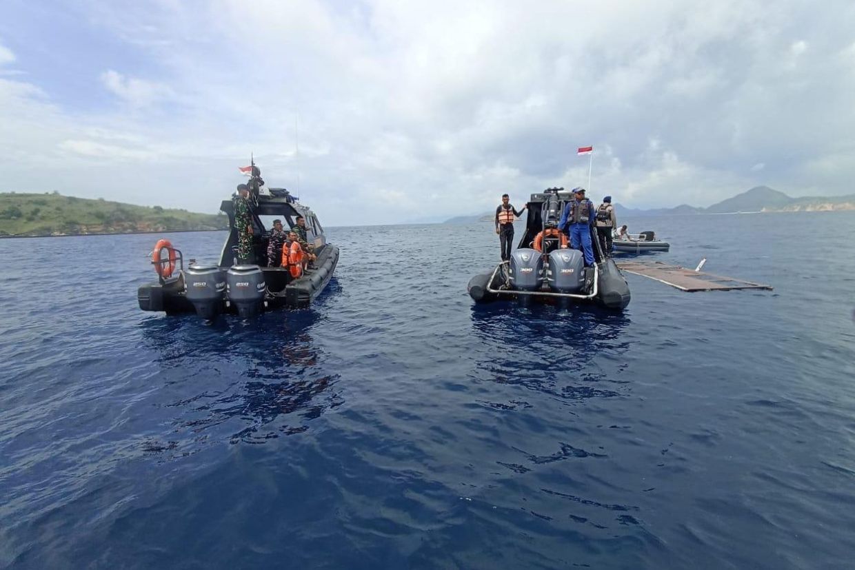 In this photo released by the Indonesian National Search and Rescue Agency (BASARNAS), rescuers examine the waters where debris believed to be from a tour boat that sank was found, near Padar Island within Komodo National Park, Indonesia. -- BASARNAS via AP