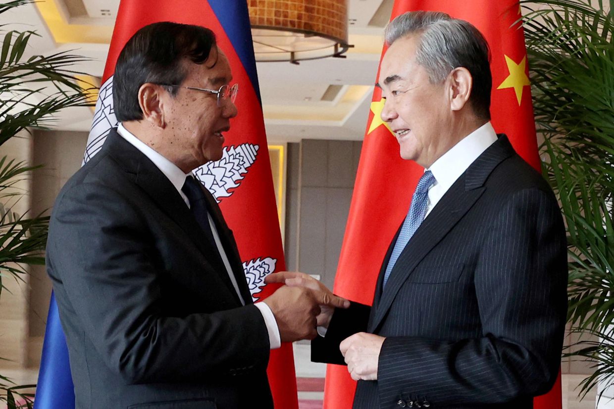 China's Foreign Minister Wang Yi (right) shaking hands with Cambodia's Deputy Prime Minister Prak Sokhonn, who is also the country's Foreign Minister, during a meeting in China's Yunnan province. China's Foreign Minister Wang Yi will host the Cambodian and Thai foreign ministers for talks in Yunnan province on December 28-29 after the two countries agreed to an immediate ceasefire on December 27, the two countries said in a joint statement, pledging to end border clashes that killed dozens of people. - Photo by Agence Kampuchea Presse (AKP) / AFP