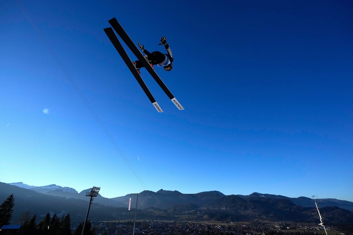 Junshiro Kobayashi, of Japan, soars through the air during a trial jump at the first stage of the Four Hills ski jumping tournament in Oberstdorf, Germany, Sunday, Dec. 28, 2025. -- AP Photo/Matthias Schrader