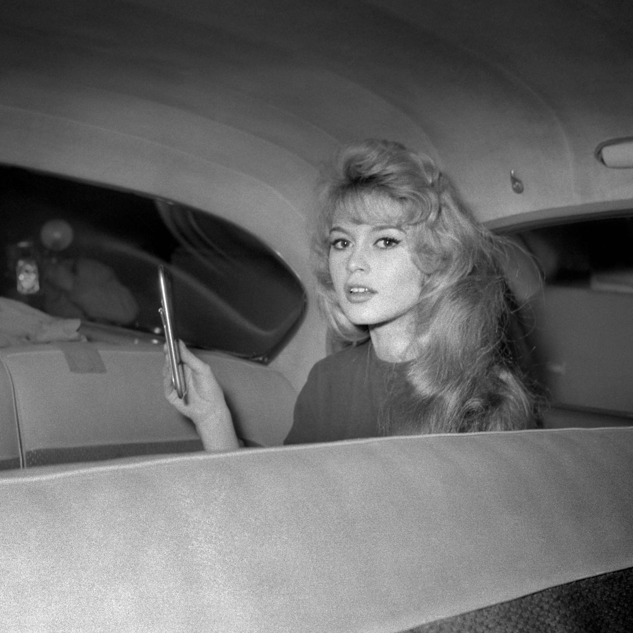 French actress Brigitte Bardot does a make-up touch-up on the set of 'En cas de malheur' directed by Claude Autant-Lara, in Paris on February 2, 1958. — Photo: AFP