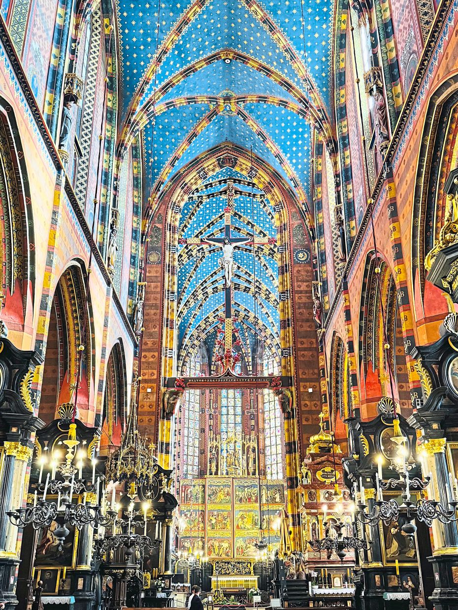 The basilica's interior is adorned with colourful stained glass and a beautifully-carved wooden altar.