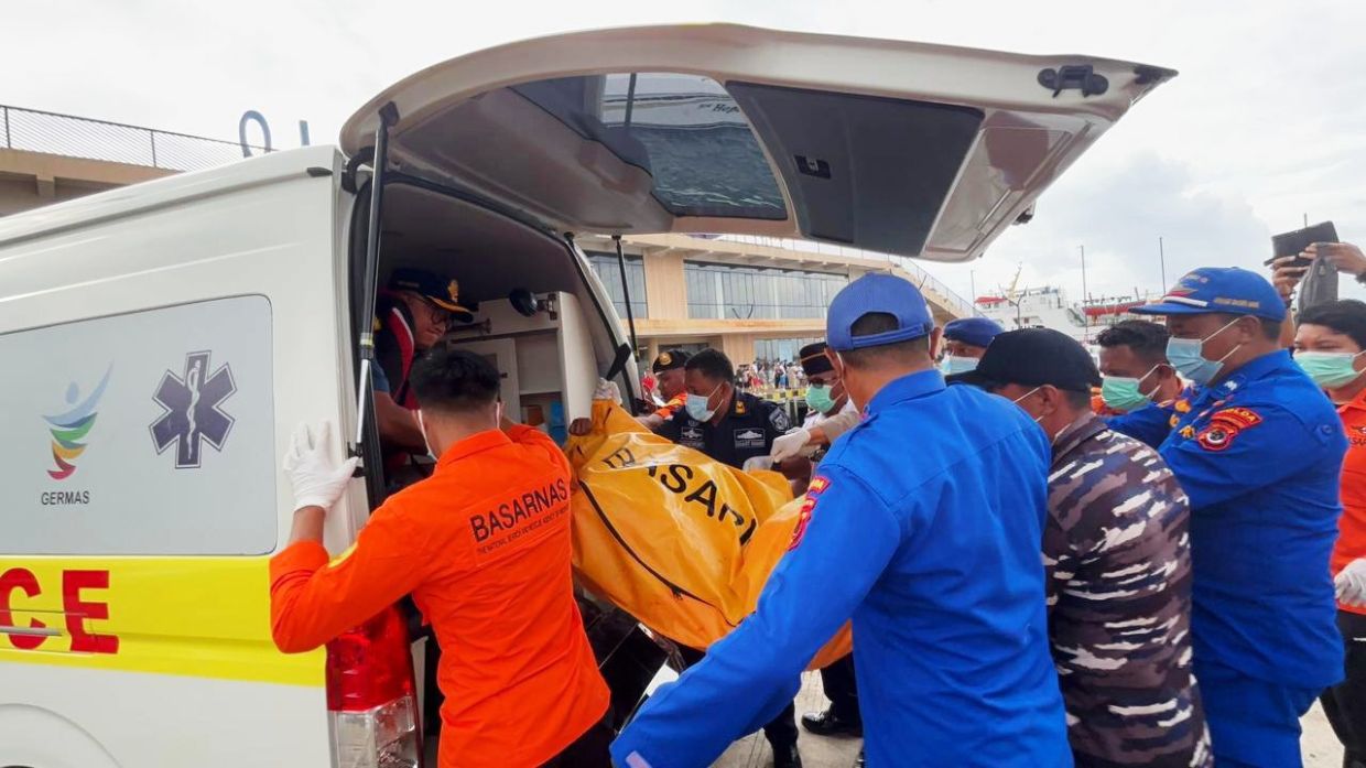 Indonesian rescuers find a body while searching for Valencia soccer coach and three children
