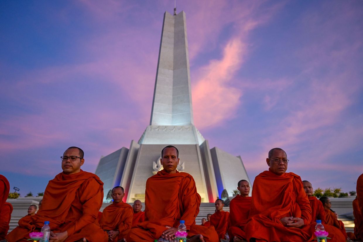 Cambodian Buddhist monks participate in a prayer for peace at the Win-Win memorial in Phnom Penh on Monday, December 29, 2025, after Thailand and Cambodia agreed to an immediate ceasefire on December 27 following renewed border clashes that killed dozens of people and displaced more than a million people this month. Thailand's army on December 29 accused Cambodia of violating a newly signed ceasefire agreement, reached after weeks of deadly border clashes, by flying more than 250 drones over its territory.-- Photo by TANG CHHIN SOTHY / AFP