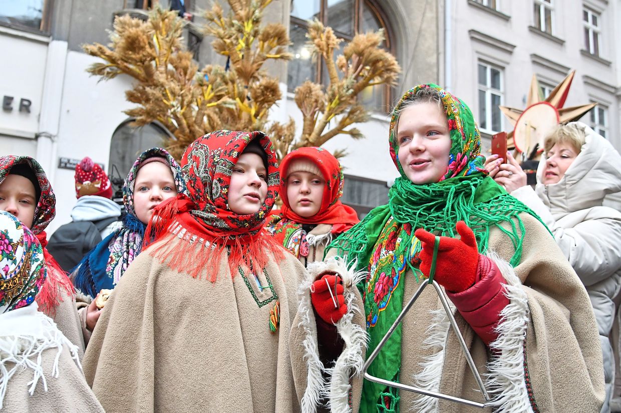 8. Ukrainian children attending a parade on Orthodox Christmas eve in downtown Lviv, Ukraine. — AP
