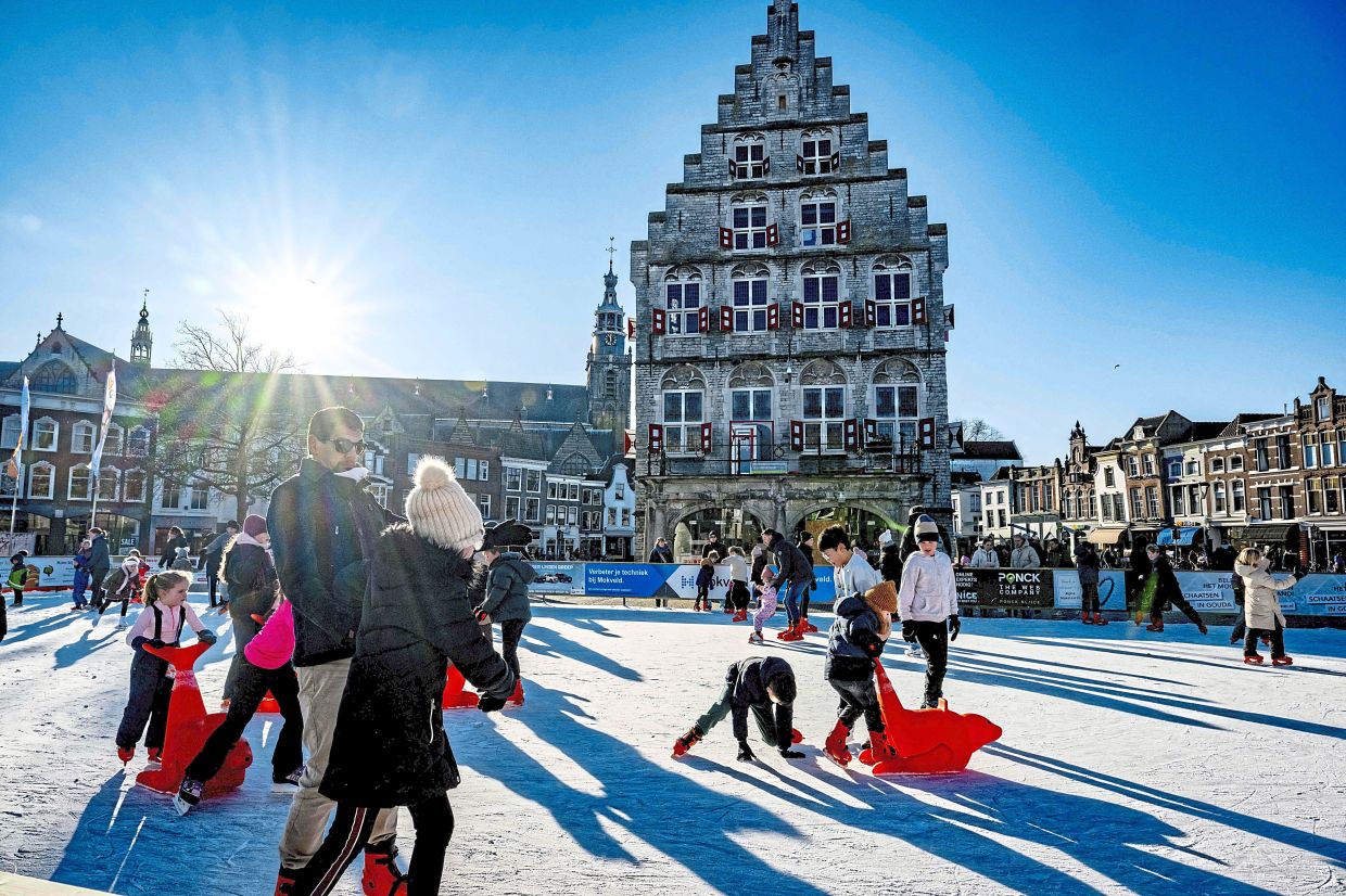 5. People skating on an artificial ice rink on Christmas Eve in Gouda, Netherlands. — AFP