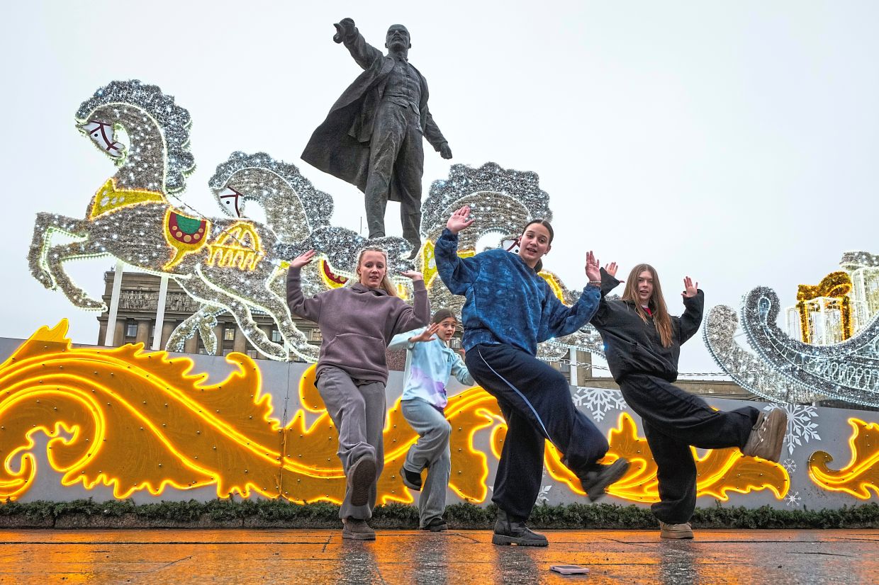 3. Girls filming their dance at a Christmas fair in St Petersburg, Russia. — AP