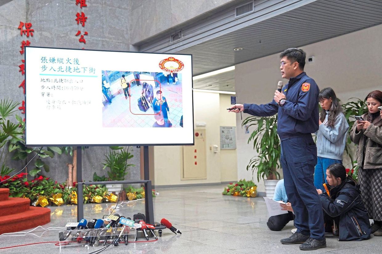 7. A police officer giving a news briefing on the deadly knife attack in Taipei. — AP