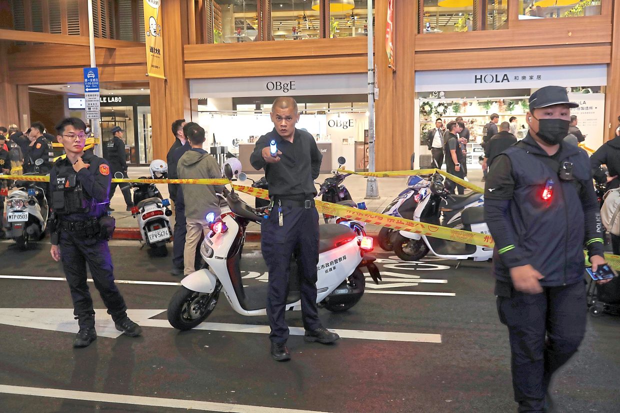 1. Taiwan police cordoning off the scene after a knife attack in Taipei. — AP