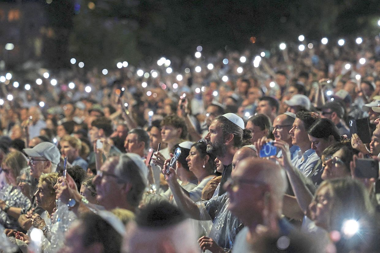 5. People attending the ‘Light Over darkness’ vigil in Sydney. — Reuters