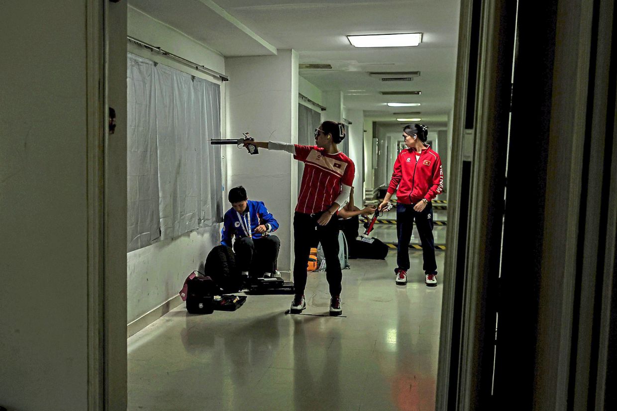 6. A Vietnamese athlete taking a moment in a quiet corridor away from the shooting range to compose himself ahead of the shooting event. — Bernama