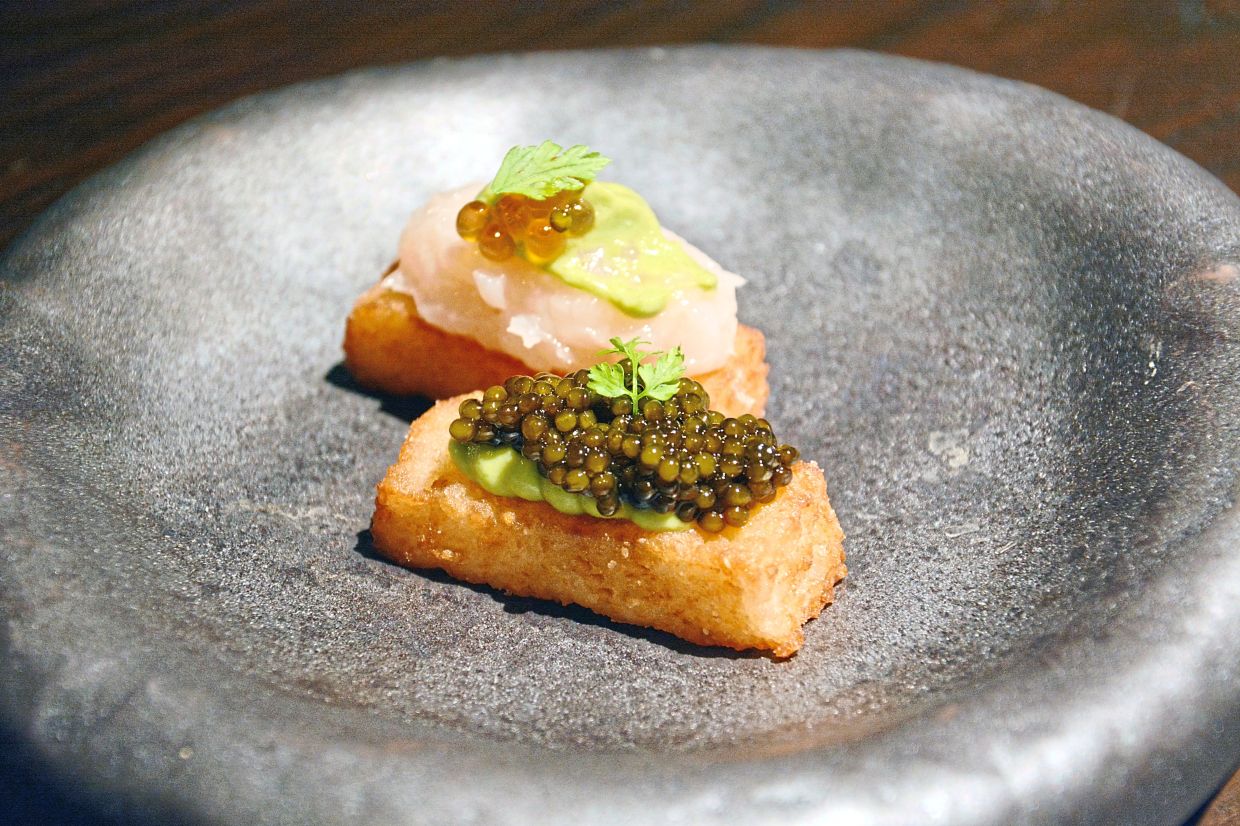 Crispy sushi rice topped with T’lur Kaluga Amur Caviar (front) and Hokkaido Scallop Tartare. 