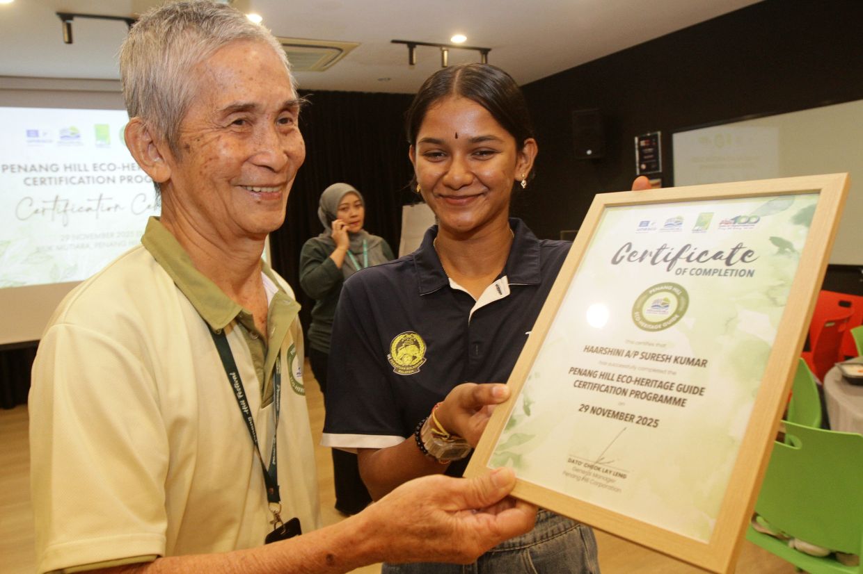 Ng (left) and Haarshini beaming with pride after being certified as Penang Hill eco-heritage guides.