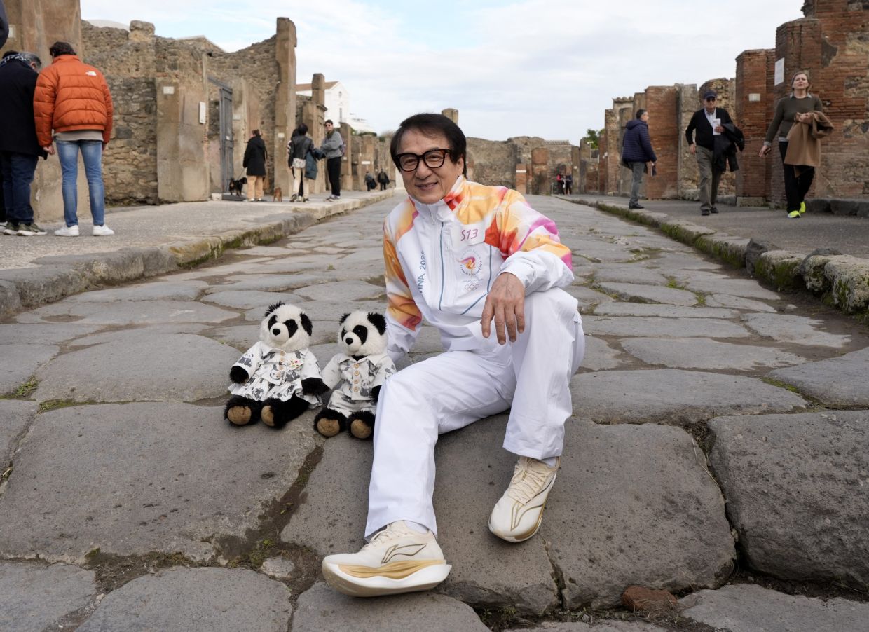 Hong Kong actor Jackie Chan holding the Olympic Torch at the archaeological area of Pompei, during the Olympic Torch relay. Photo: Reuters