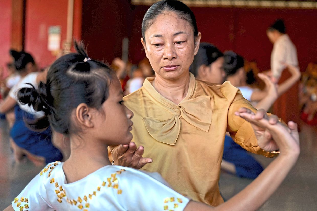 'I have to watch them from hair to toe so that in the future they could be our heirs,' says Hang Sophea. Photo: AFP