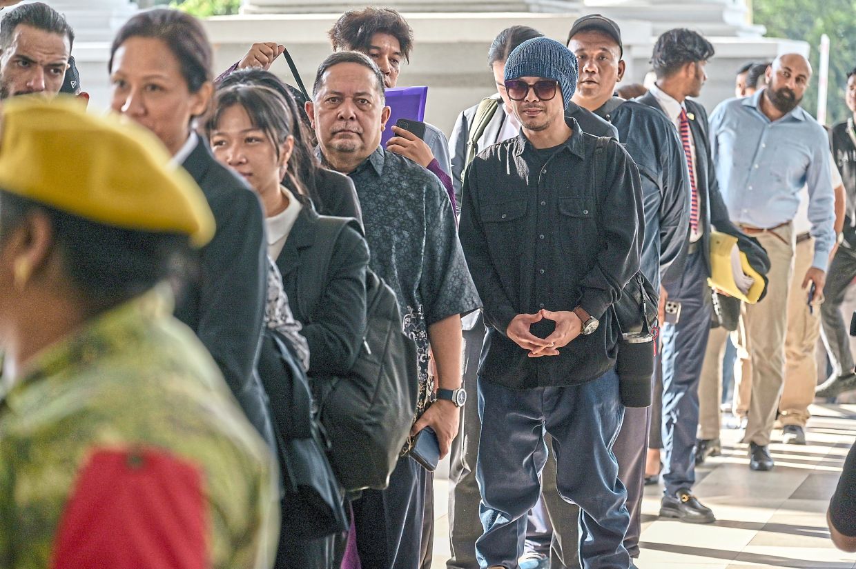 Namewee (in dark glasses) on the way to court on Dec 22. — Photo: Bernama 