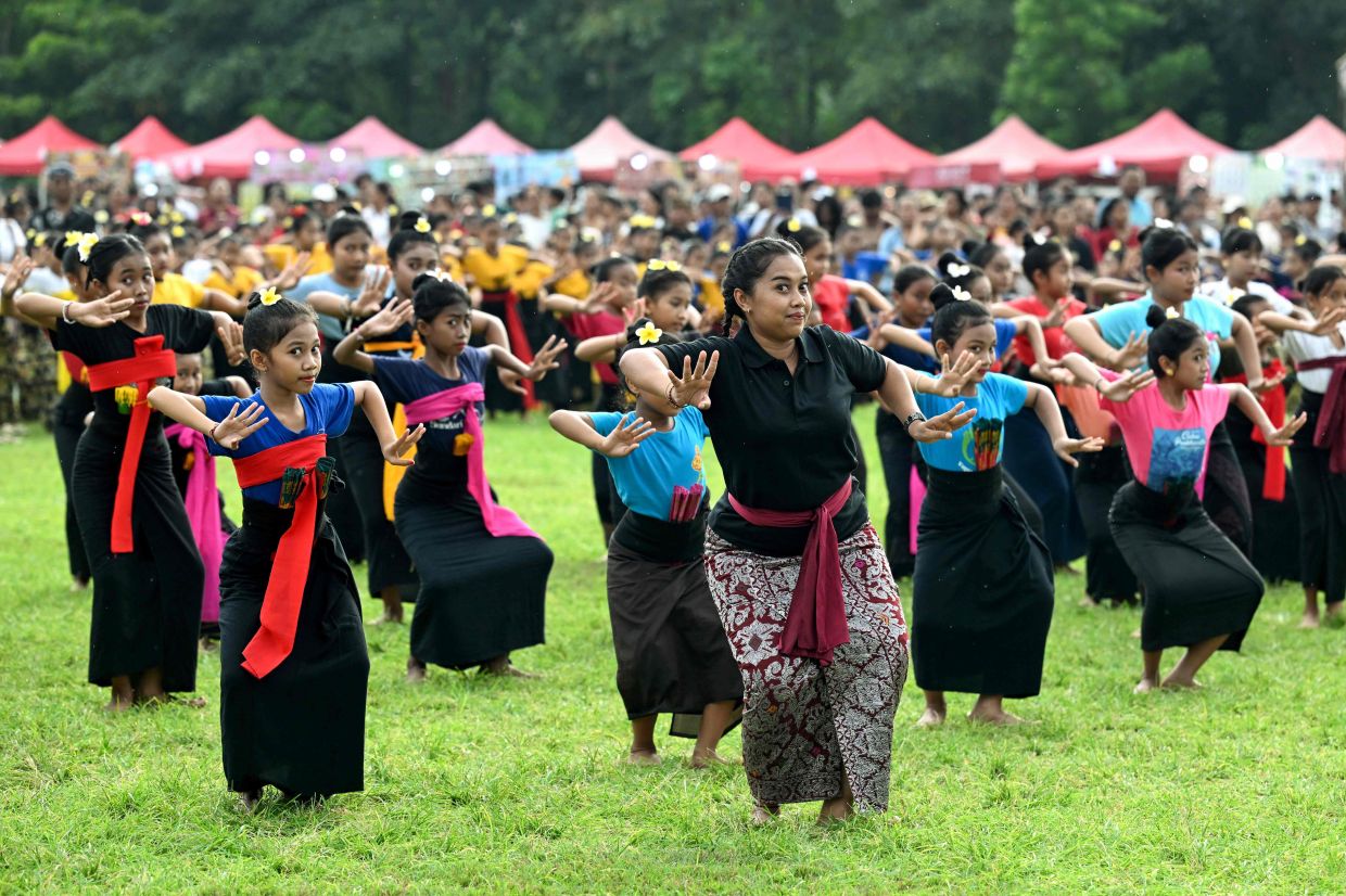 Children performing a traditional Balinese dance to release the sun of 2025, and to welcome the sun of 2026, during a New Year's Eve celebration in Denpasar, on Indonesia's resort island of Bali on Dec 31, 2025. - AFP