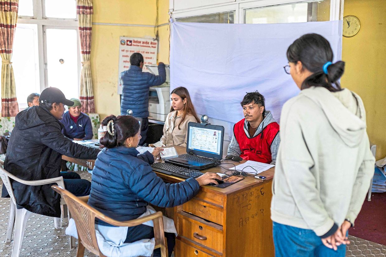 Roll update: Poll officials registering people’s names in the voter list at the District Election Office in Lalitpur, ahead of Nepal’s parliamentary elections. — AFP