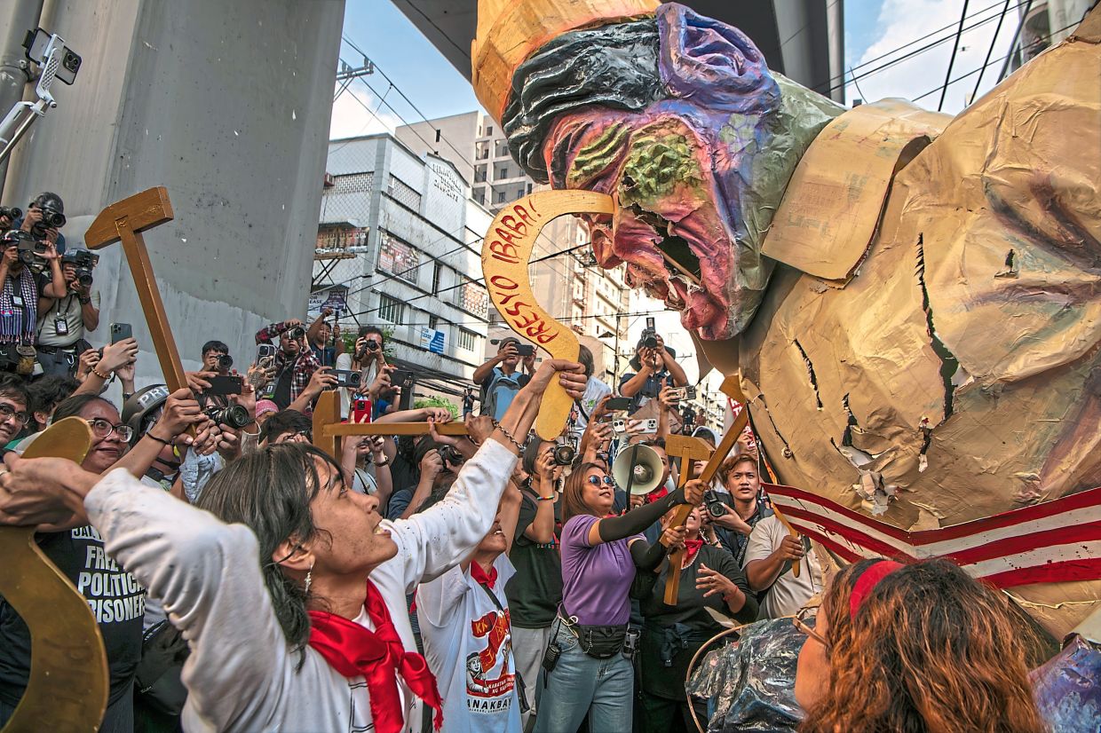 An effigy of Marcos is defaced during an anti-corruption rally in Manila. — Jes Aznar/The New York Times