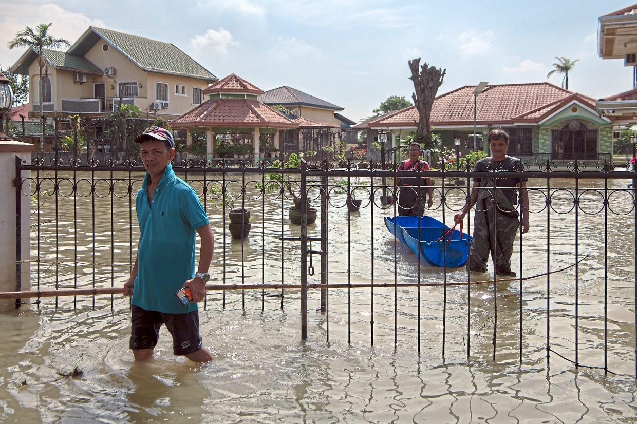 A flooded street in Calumpit in Bulacan Province. The repeated flooding in Bulacan has become emblematic of a sprawling corruption scandal in the Philippines.— Jes Aznar/The New York Times