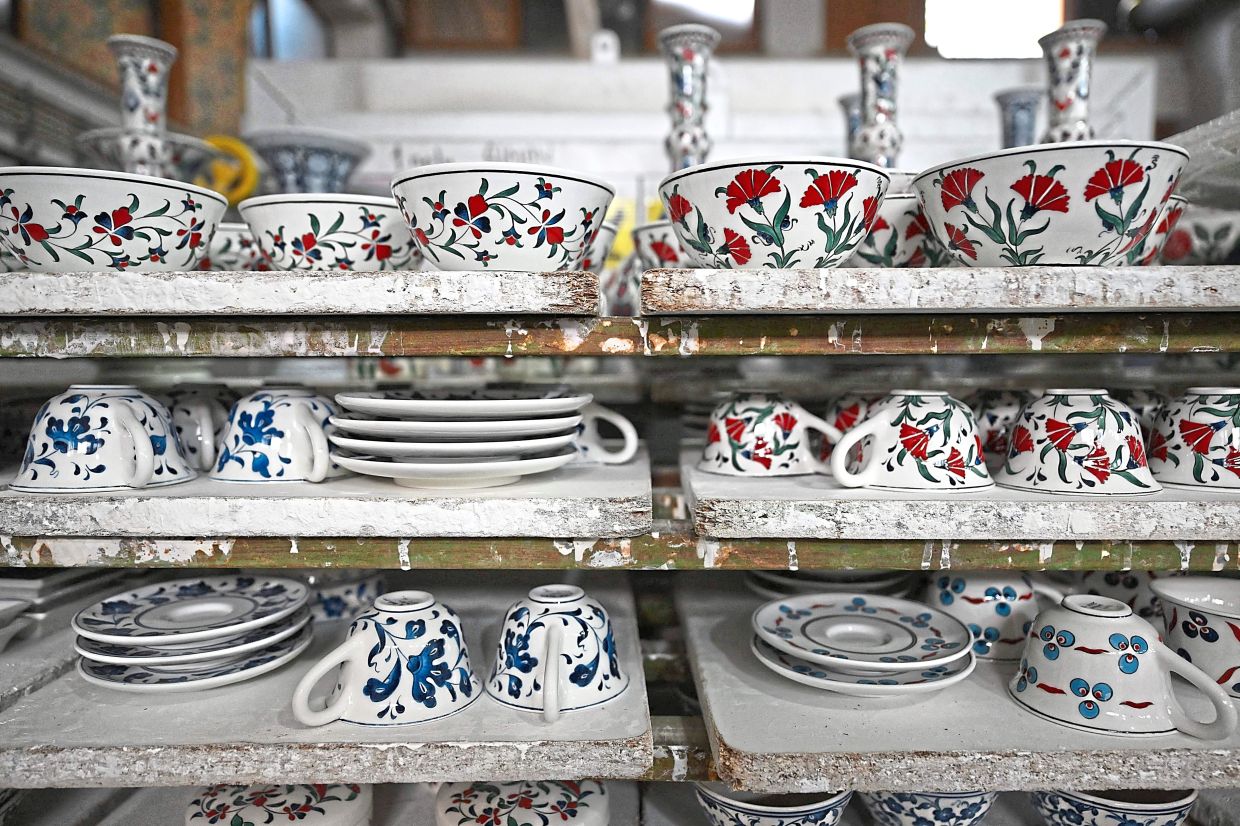 Painted bowls, cups and saucers waiting for the oven process in Iznik. — AFP