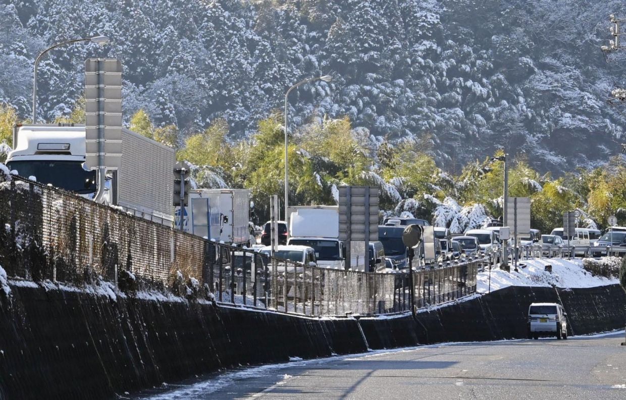 Snow traps vehicles in a 23km traffic jam on highway in western Japan