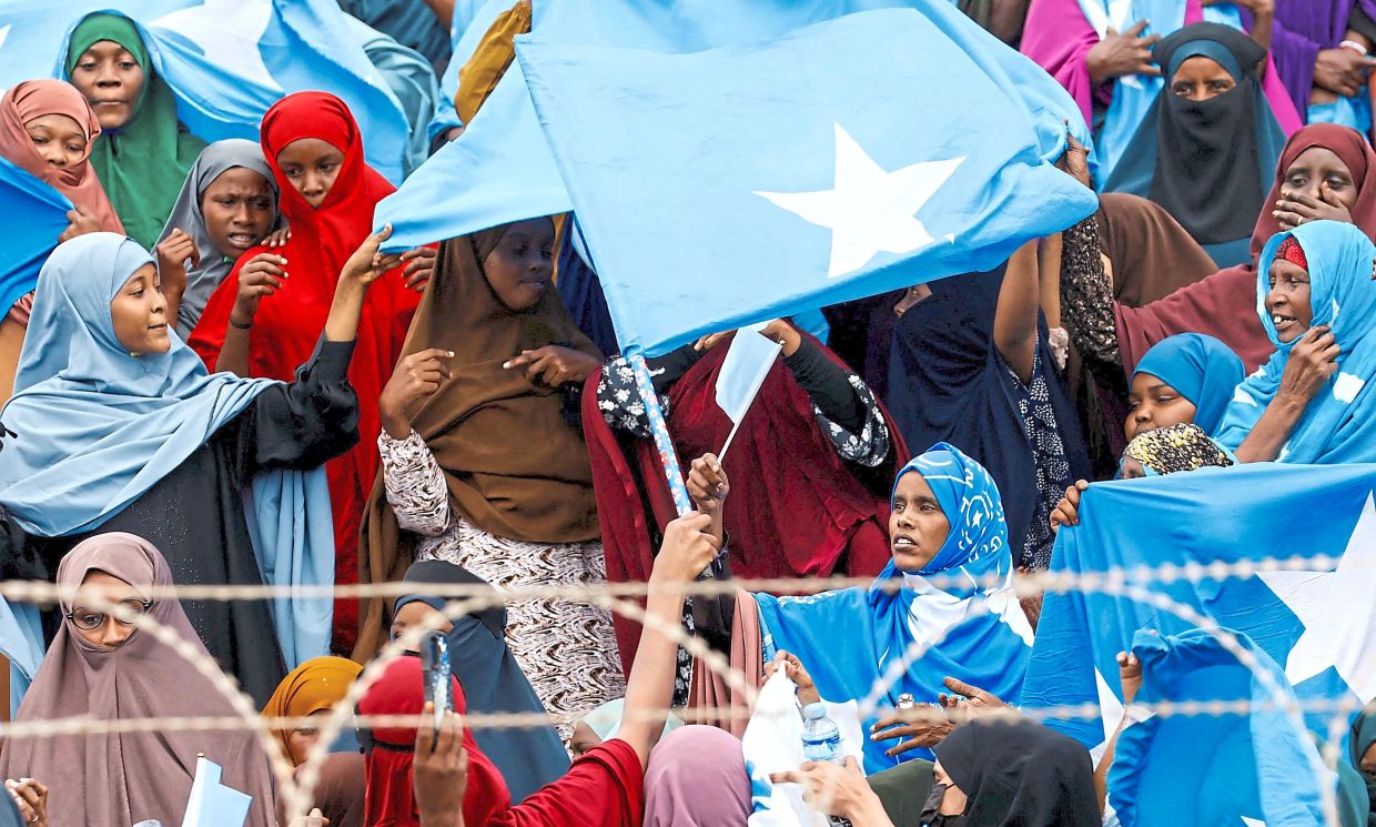 Reshaping regional dynamics : Women waving Somali national flags in a protest after Israel became the first country to formally recognise the self-declared Republic of Somaliland. — Reuters