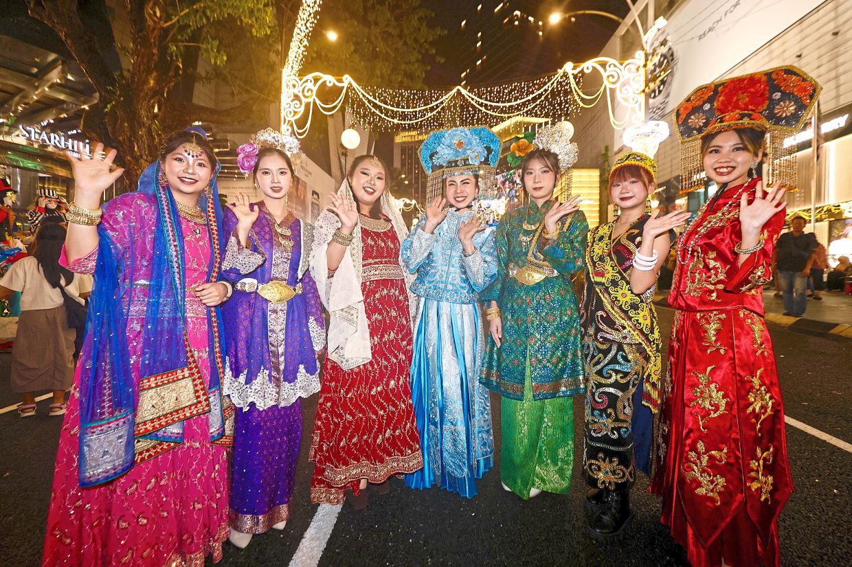Eager onlookers: Costumed visitors posing for a photo during the ‘I Lite U’ launch event in Kuala Lumpur. — FAIHAN GHANI/The Star