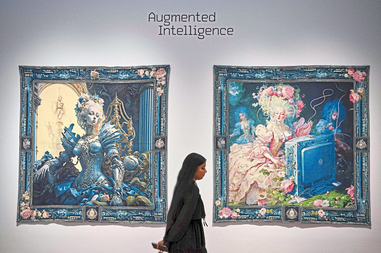 A person walks past AI artwork series created by Grimes, Mac Boucher, Mary Jacobo and Eurypheus called 'Marie Antoinette After the Singularity #1' and #2'at a press preview for 'Augmented Intelligence' at Christie's in New York last February. Photo: AFP 