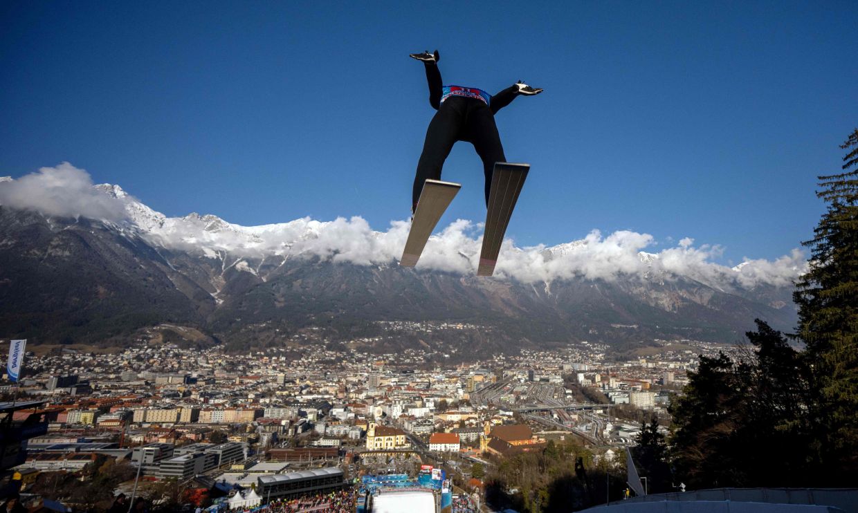 Japan's Ryoyu Kobayashi soars through the air during the trial round for the Men's Individual Large Hill HS128 event of the FIS Ski Jumping World Cup, the third leg of the Four Hills Tournament, in Innsbruck, Austria on Sunday, January 4 , 2026. -- Photo by GEORG HOCHMUTH / APA / AFP