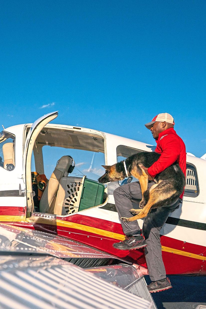 Volunteer pilot CJ Owens loading a shelter pet onto his plane.