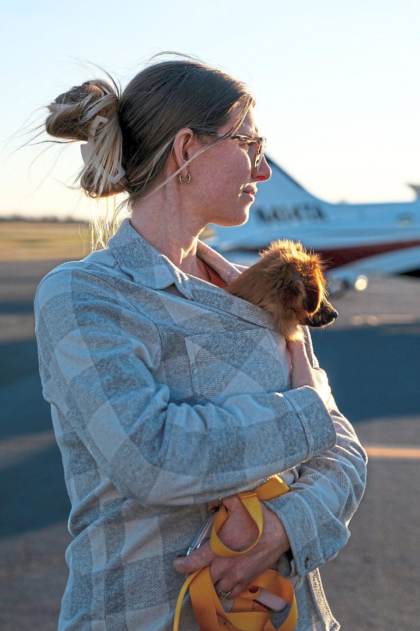 Volunteer Sara Aveni holding Melvin the puppy.
