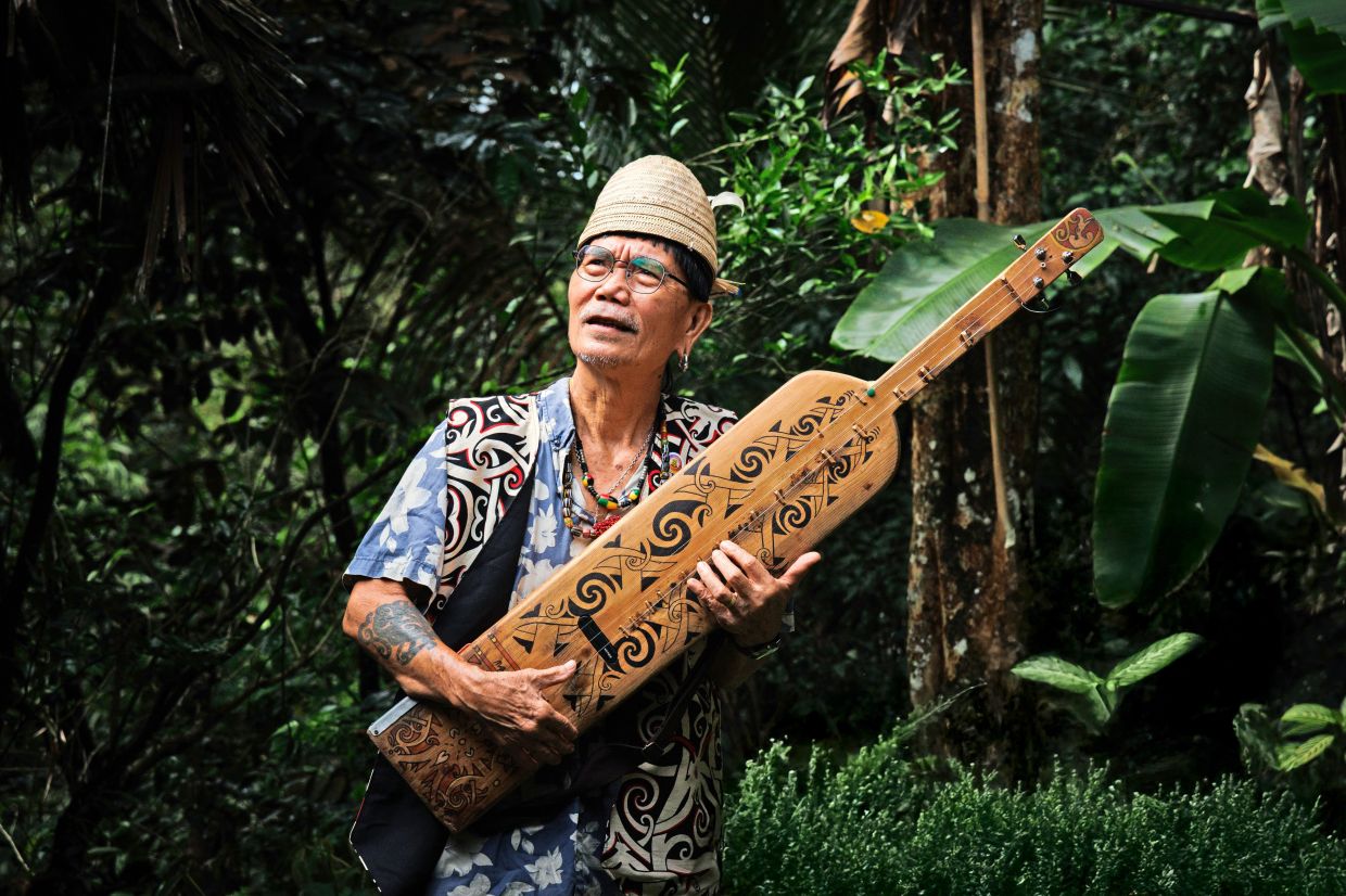 Mathew keeps traditional Orang Ulu tunes alive on his sape.