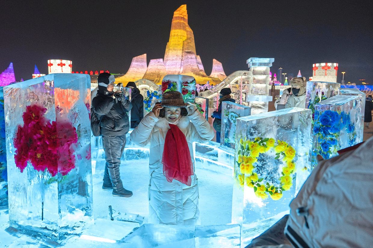 Spectacular ice: Visitors enjoying the festival in Harbin. — AP