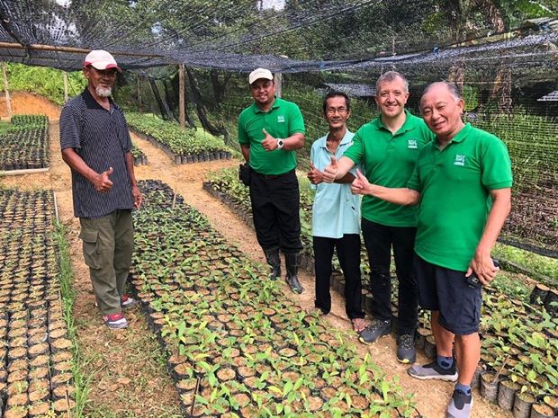 An early moment from Project RELeaf: (From right, in green): former Nestle Agricultural Services head the late Yong Lee Keng who was a driving force behind the initiative, Aranols and Hasidin.