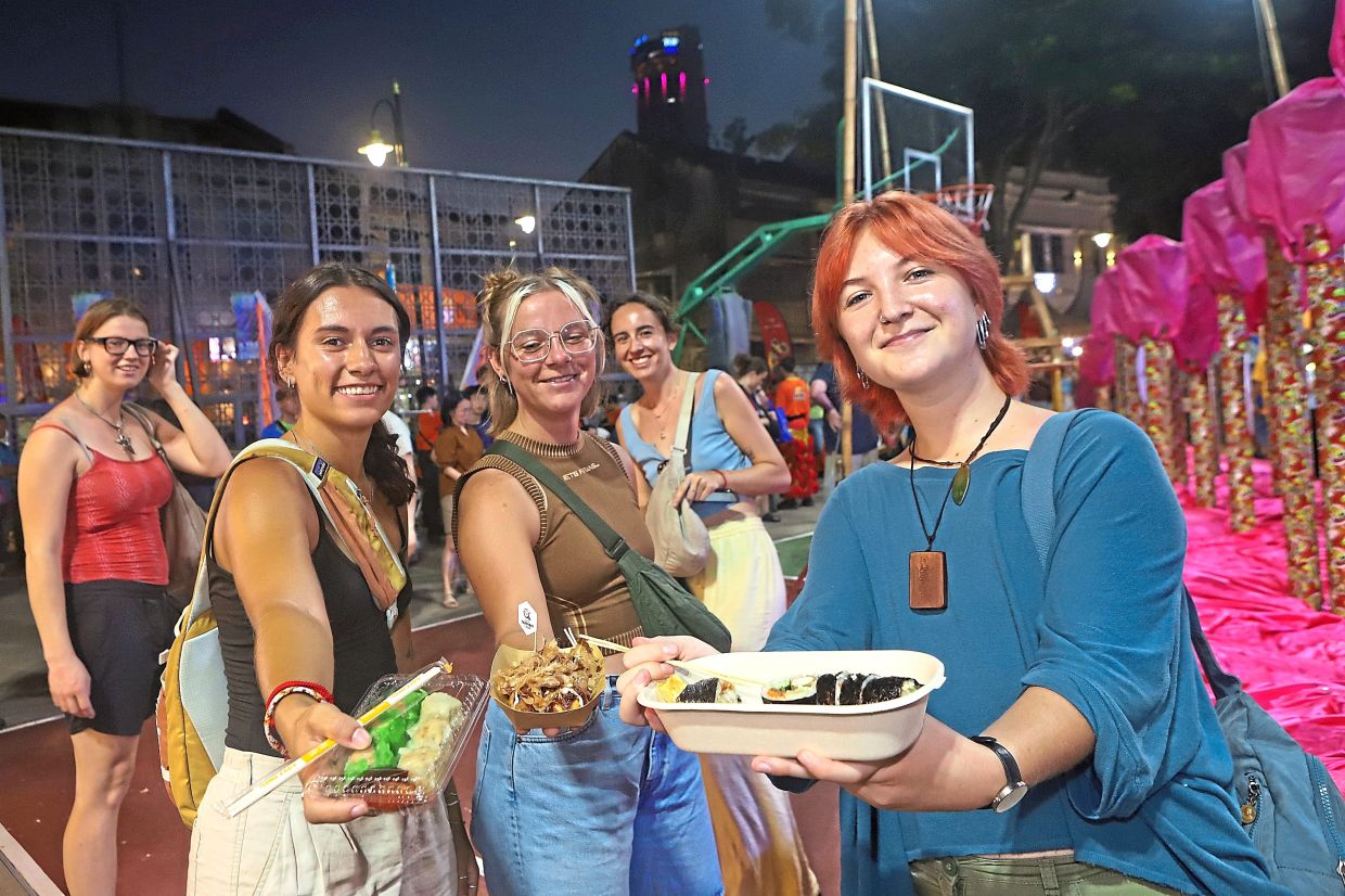 Penang is a top travel destination due to its great culinary offerings, as seen with this group of tourists sampling food during an event in Armenian Park last year.