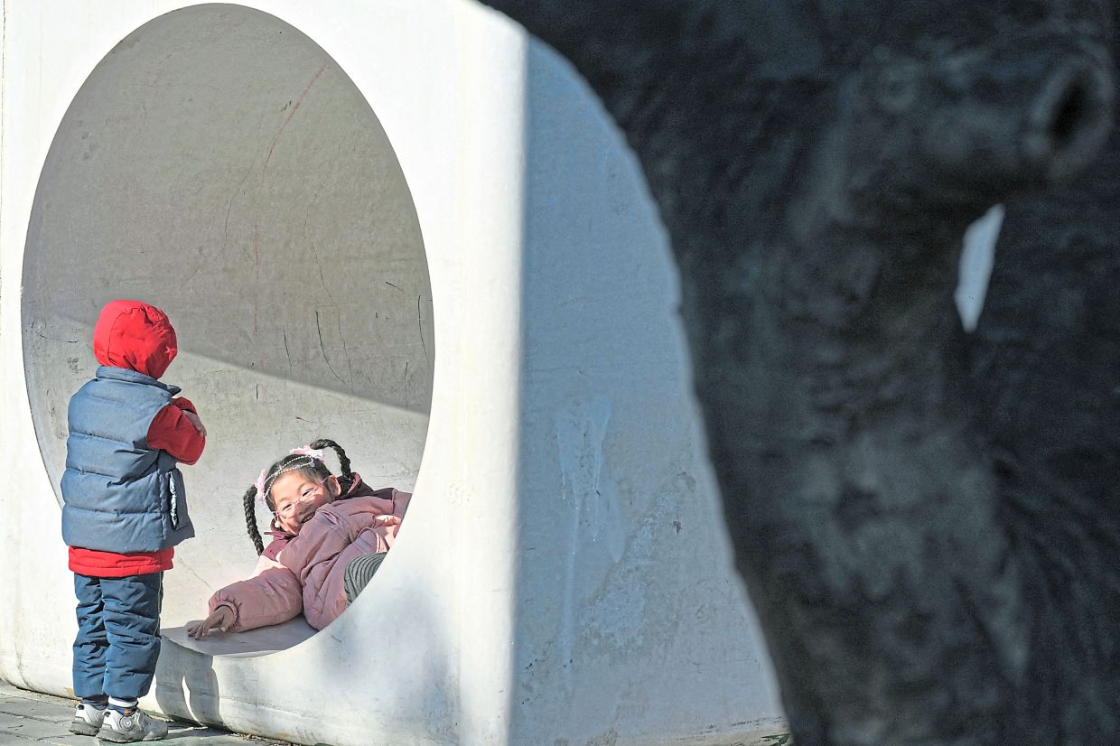 Chidhood joy: Children playing at a park in Beijing. There were just 9.54 million births in the country in 2024, half the number than in 2016. — AFP