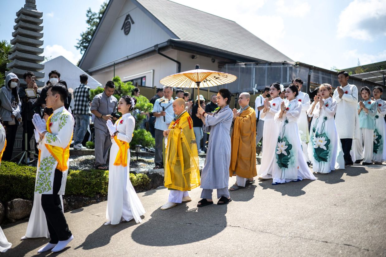 File photo ofVietnamese nun Thich Tam Tri (third from left) taking part in a Buddhist ceremony with members of the Vietnamese community at Daionji temple in the city of Honjo, Saitama Prefecture. - AFP