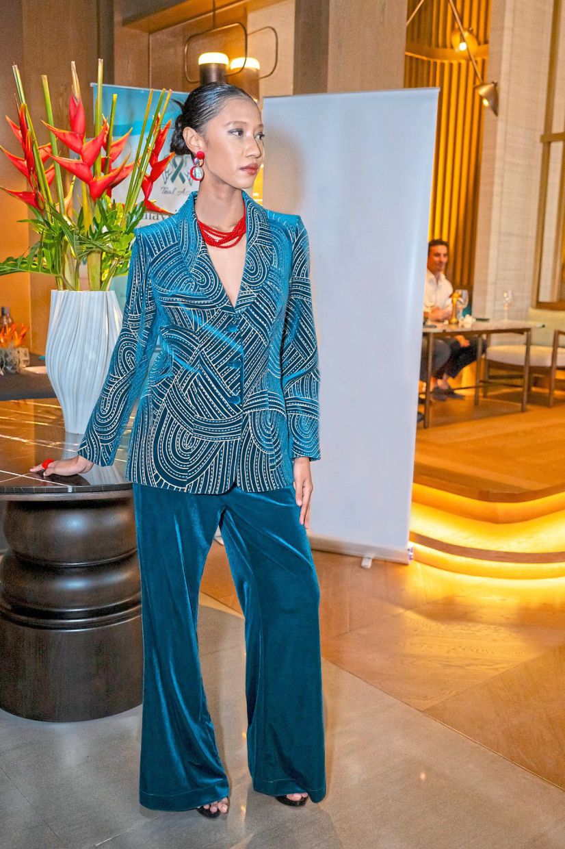 This two-piece creation is made even more striking with coral red accessories. Photo: Romyda KL