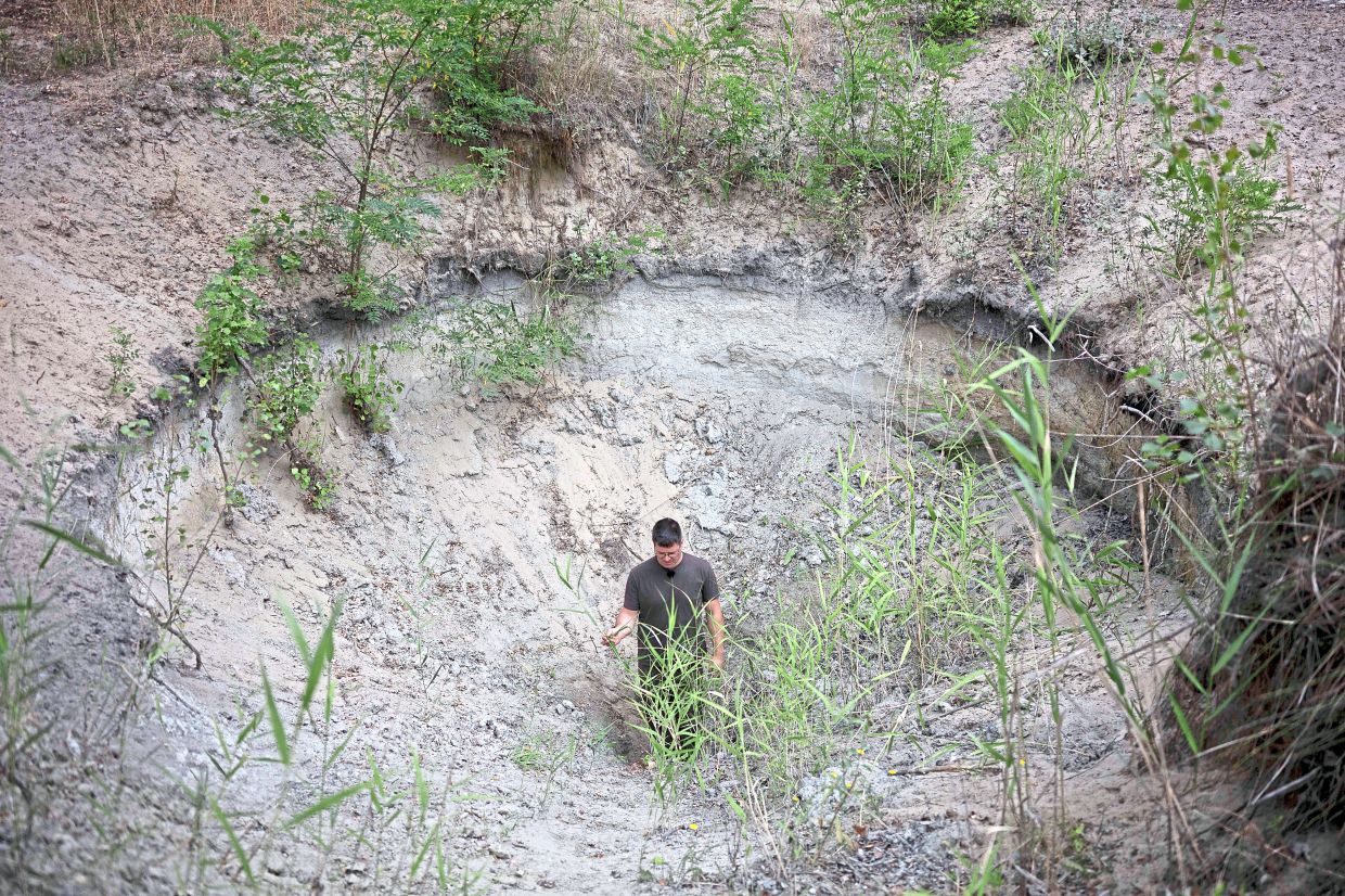 A water guardians standing in a dried up watering hole in Kiskunmajsa. 