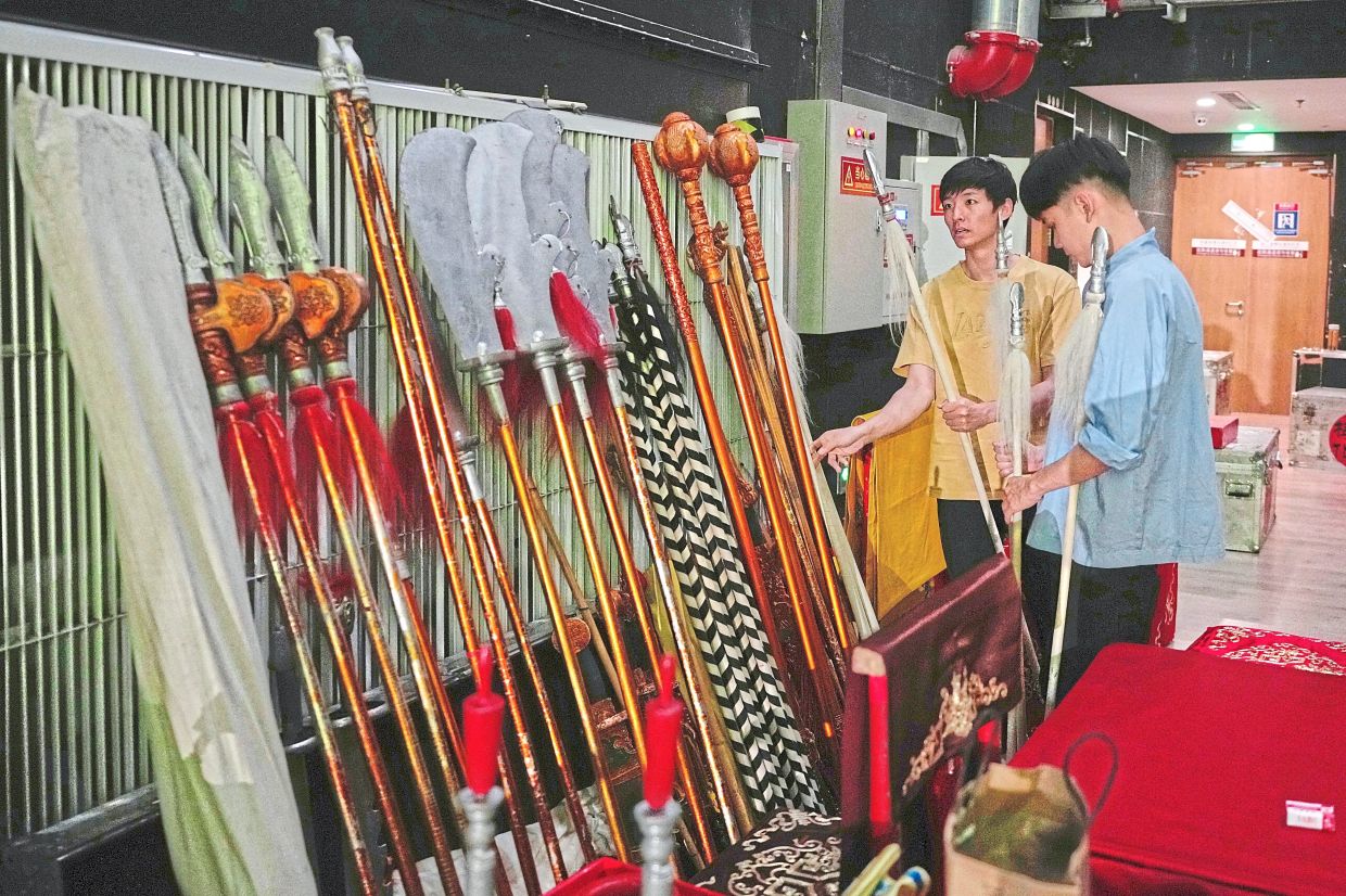 Staff arrange props backstage before a Peking opera show at a theatre in Beijing. Photo: AP 