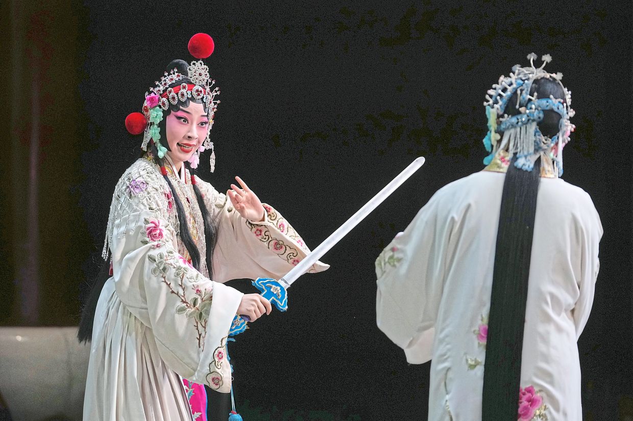 An increasing number of young Peking opera artists, like Zhang (left), are dedicating years to mastering its demanding techniques. Photo: AP