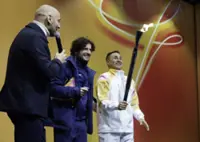 Olympics-Flame reaches Italian city of Bologna a month before the Games begin