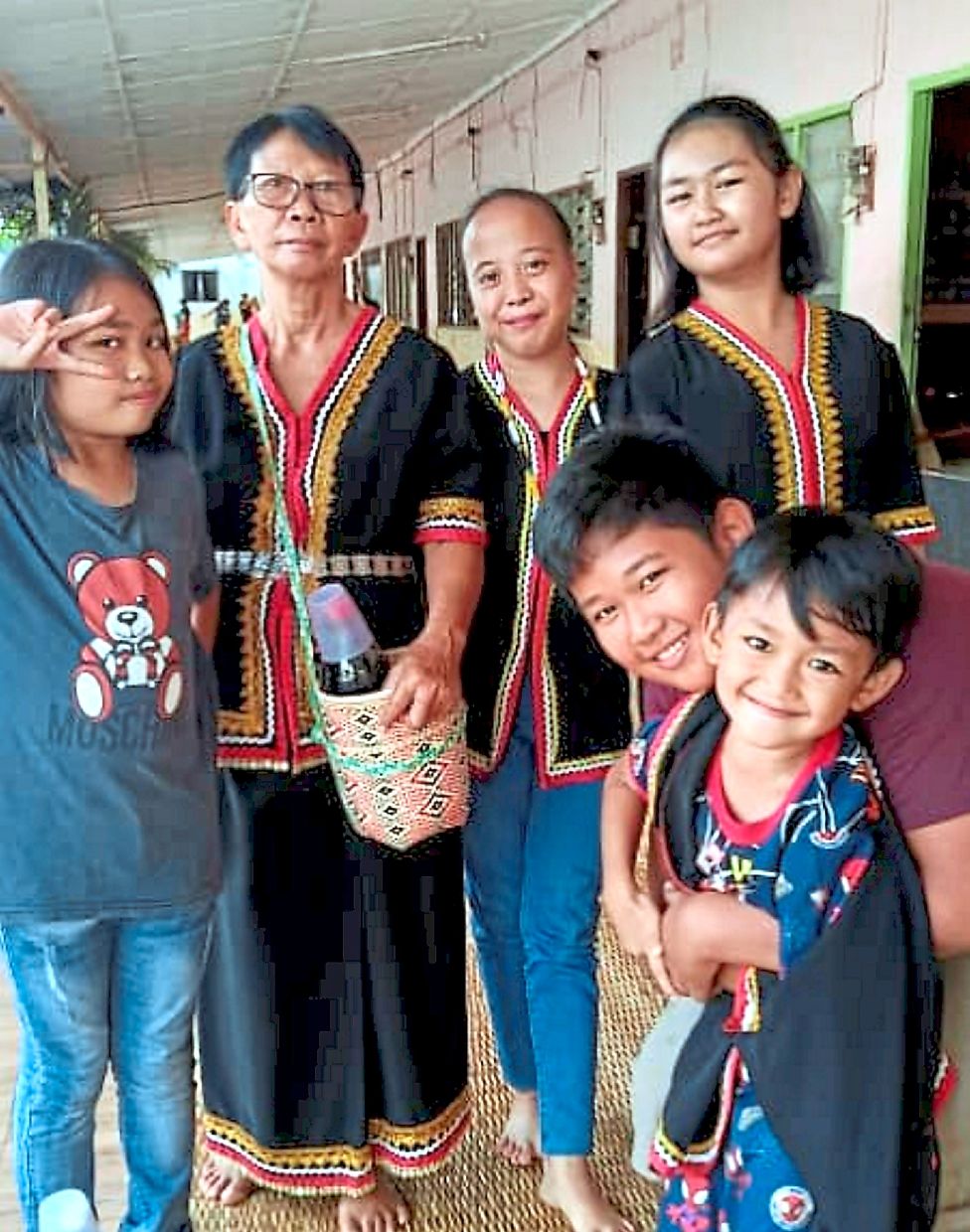 Deo (right) with his grandmother and siblings before he was diagnosed. 