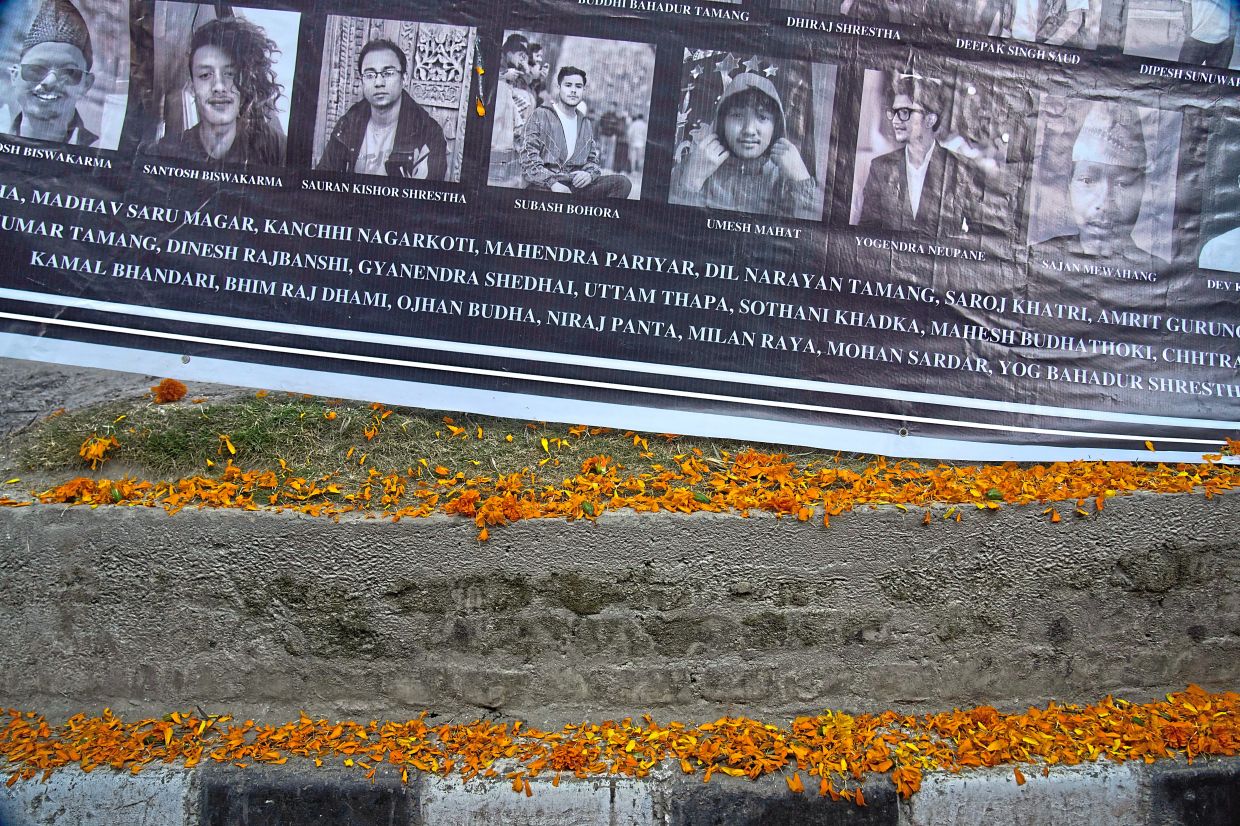 Unbearable sacrifice: A banner in Kathmandu bearing photos and names of people killed during the September protest is displayed during a gathering to pay respect to the victims. — AP
