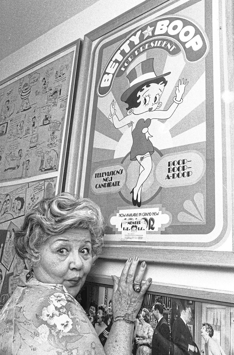 Mae Questel, who provided the loopy, child-like voice of cartoon characters Betty Boop and Olive Oyl, poses in this 1978 file photo with a poster of Betty Boop. — AP