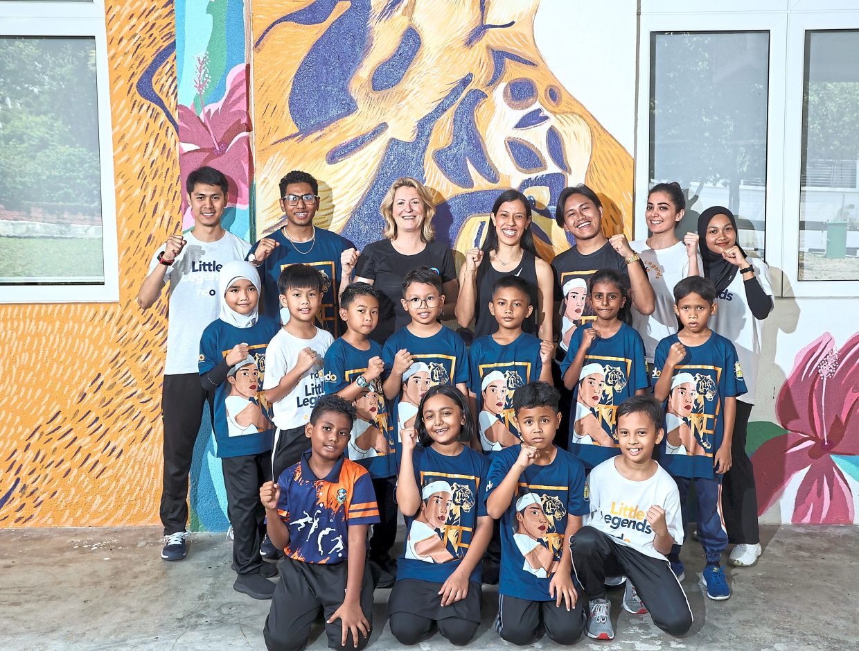 NDO reaches children who might never otherwise step onto a squash court, giving them tools for life, says Nicol (back row, centre), pictured with Irving (back row, third from left).