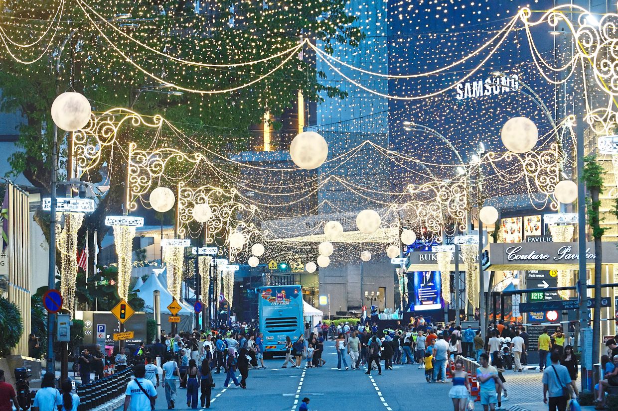 As night falls, the lively streets of Bukit Bintang begin to light up. — FAIHAN GHANI/The Star