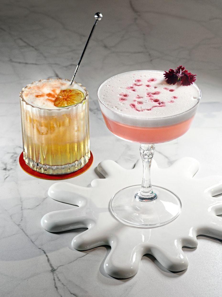M Social Resort Penang’s Breezy Bites, located beside the hotel pool, has a ambience befitting its name. — Photos: JEREMY TAN/The Star and courtesy photo Pink Peranakan (right) and classic Whiskey Sour (left) at Breezy Bites.